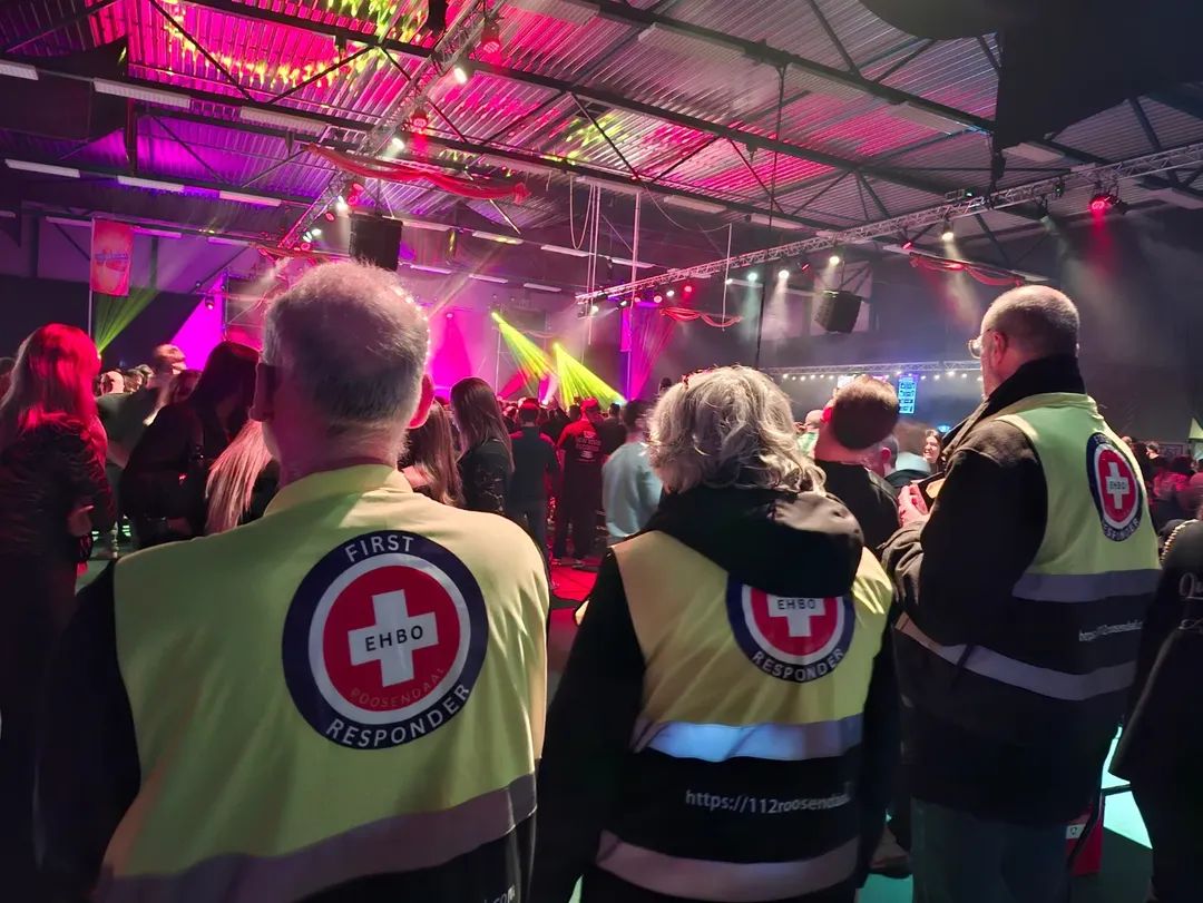 Three EHBO Roosendaal SACE first-aiders with the team logo on their vests during an event